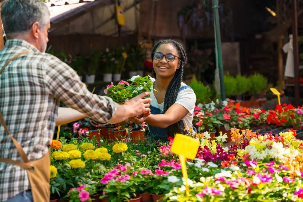 happy-female-customer-buying-flowers-from-a-garden-