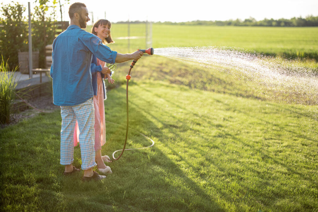 lovely couple watering lawn at backyard 2022 07 05 15 16 56 utc