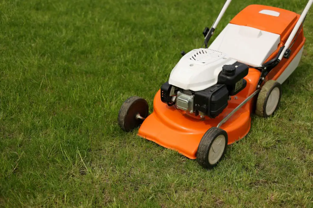 top-view-of-modern-orange-grey-electric-lawn-mower-
